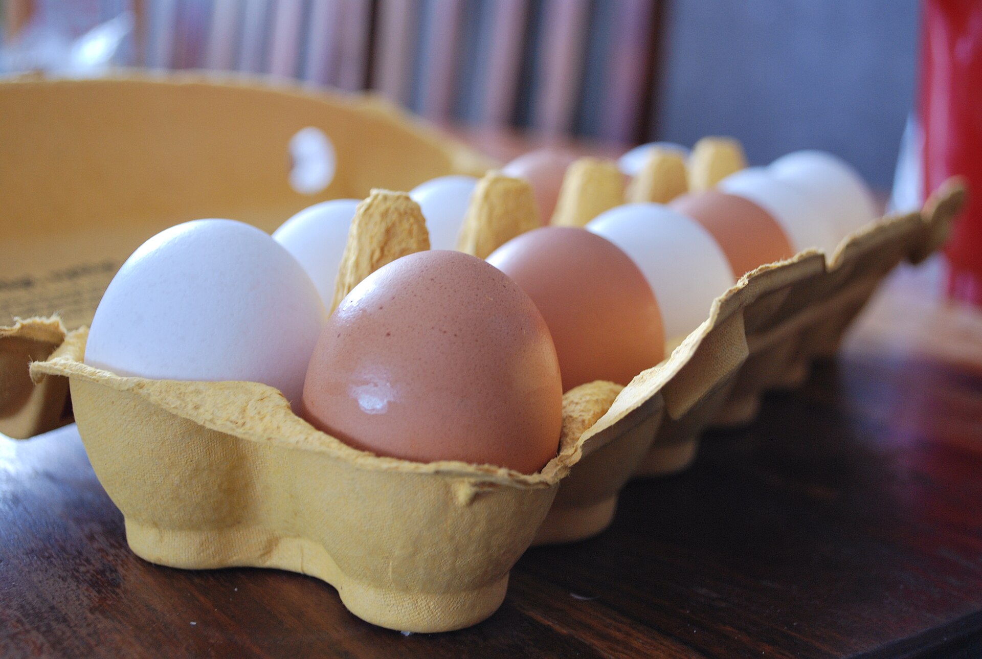 Mixed brown and white eggs in a cardboard carton