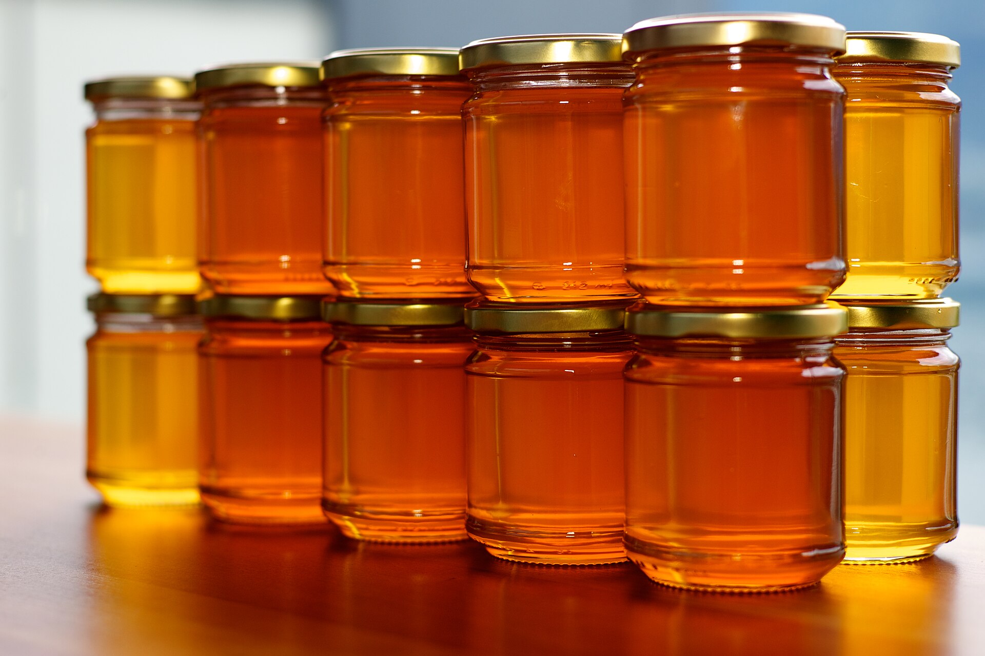 Jars of golden honey glowing in natural light
